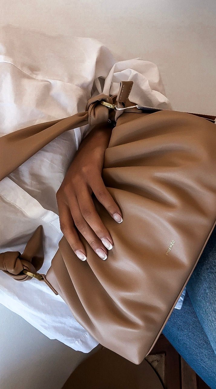 Camel leather bag and denim jacket — everyday boutique pieces at Jayden P Boutique in Carlsbad, CA