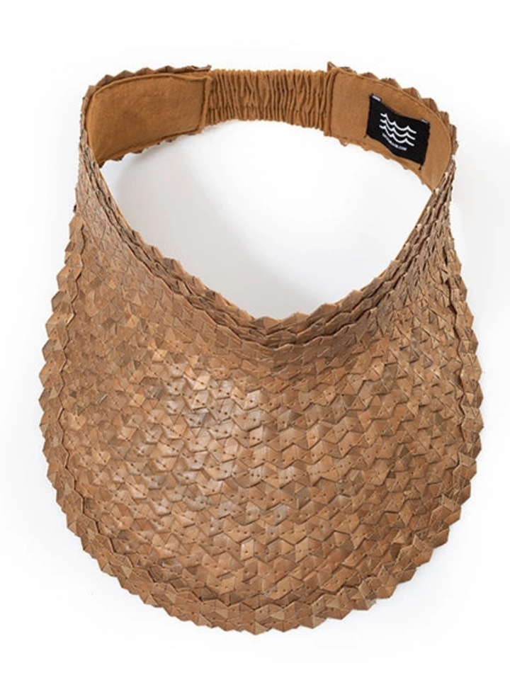 Tan handwoven straw bag with geometric, scale-like weave and a black label patch.