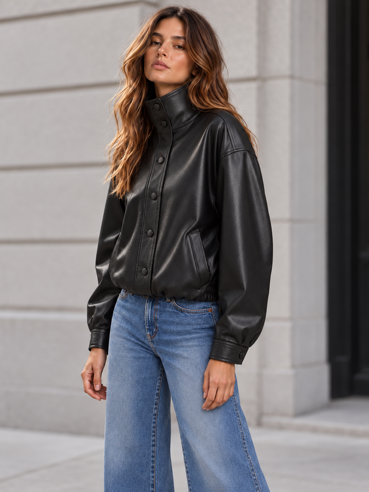 Daze Denim Phantom Faux Leather Funnel Neck Jacket in black — three-quarter city view