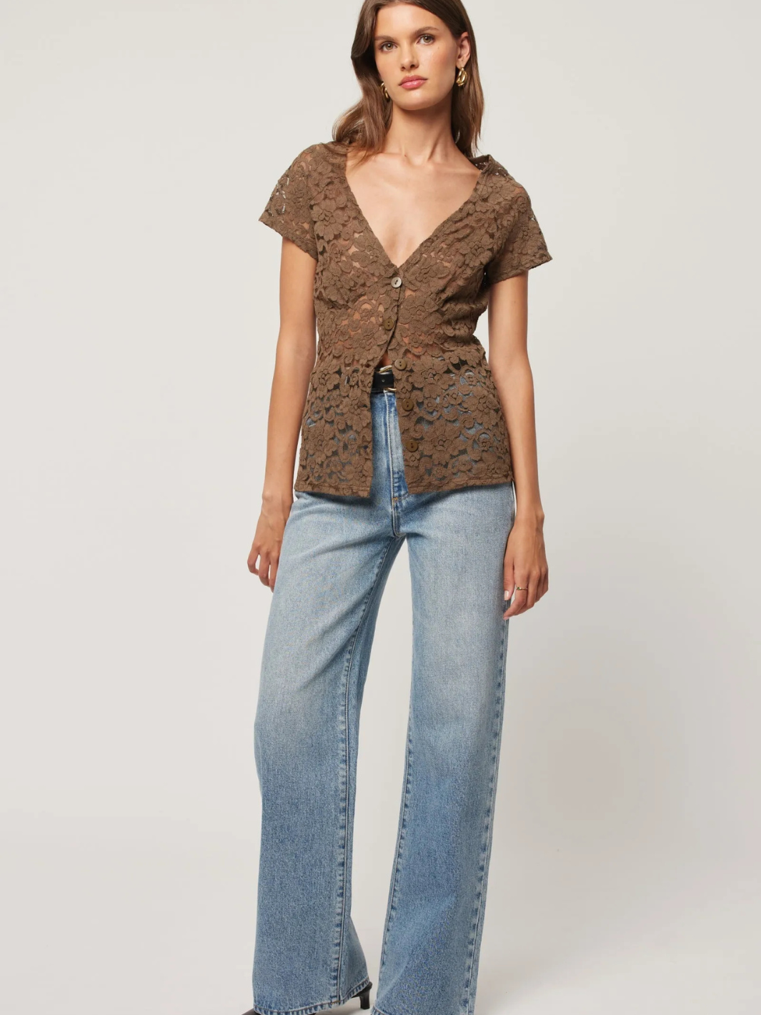 Stylish model wearing ROLLAS - Sailor Scoop Jeans paired with a chic top, showcasing a trendy outfit.