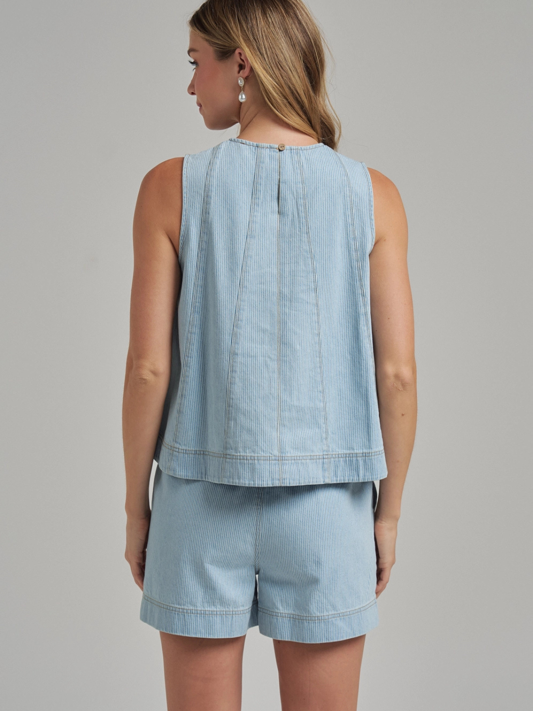 The Sutton Pinstripe Denim Shorts styled with a matching Sutton tank for a tailored, casual warm-weather look.