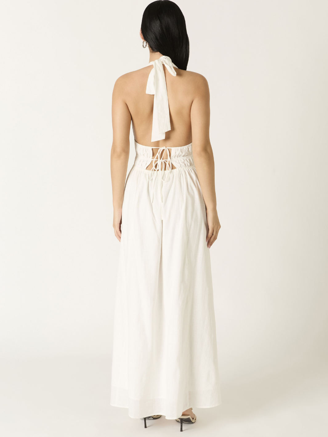 Ivory Soleil Plunge Halter Maxi Dress back view with halter neck tie and lace-up back, flowing A-line skirt.