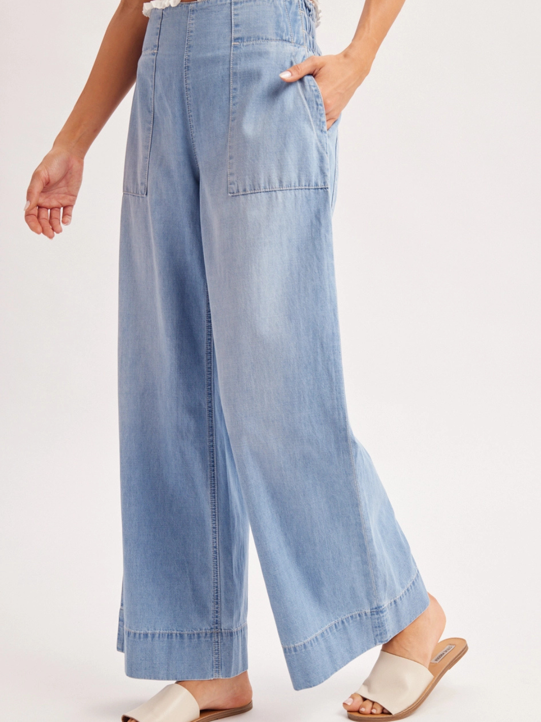 The Sailor Wide-Leg Denim Trouser in light-wash denim with a relaxed, flowing silhouette and large patch pockets.