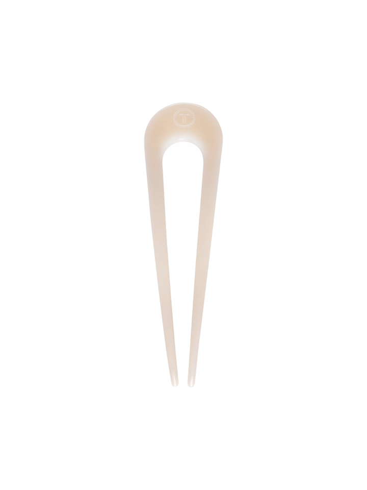 Beige TELETIES French Hair Pin with TT logo, curved U-shape and two slim prongs.