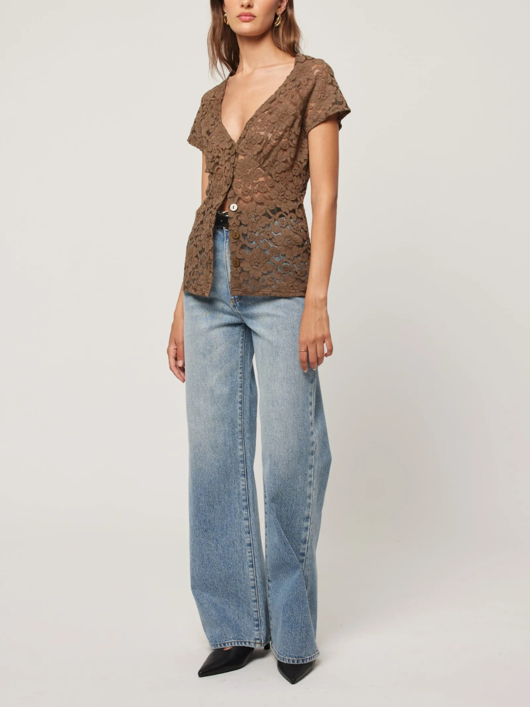 Stylish model showcasing ROLLAS - Sailor Scoop Jeans paired with a chic top for a trendy look.