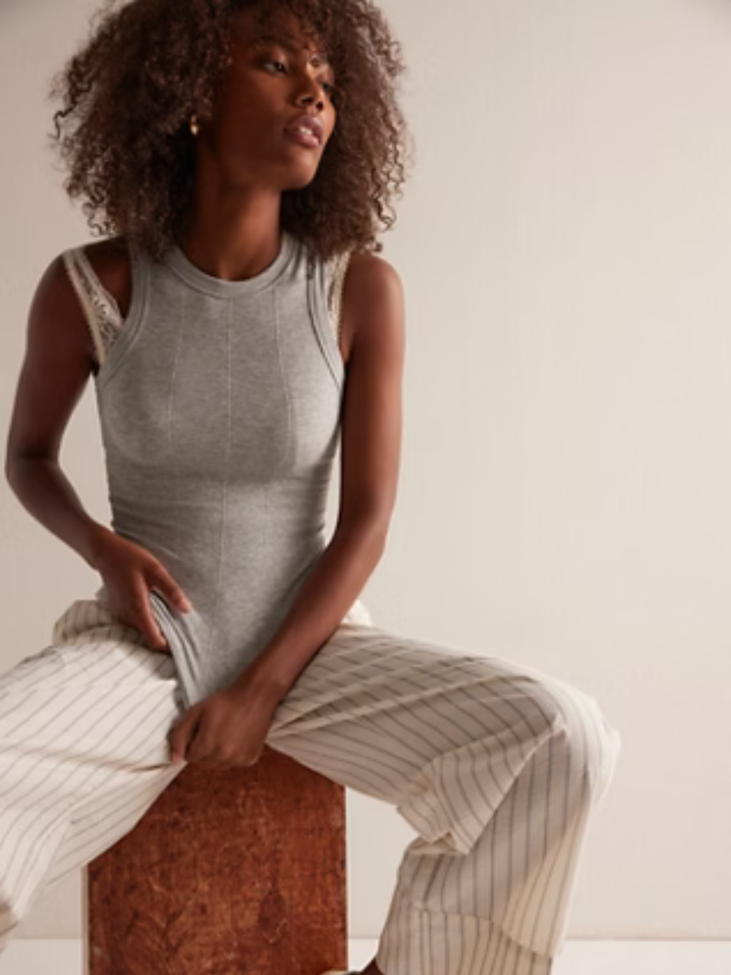 Model wearing Free People So Soft Seamless Modal Tank in grey, buttery-smooth base layer with sculpting seamed details.
