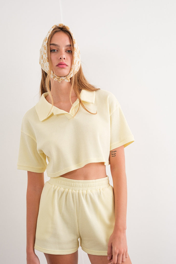 This stylish River Waffle Crop Polo Top is perfect for your wardrobe. Featuring a fashionable polo top collar and cropped design, it's crafted with a waffle knit material that's 65% polyester and 35% cotton for a comfortable and durable fit.