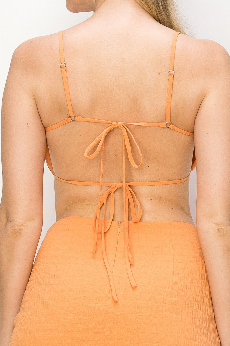 Be stylish and comfortable in the Ariel Bandeau Tie Crop Top in orange. This bandeau style top features adjustable straps, tie back, and smocked details for a perfect fit. Crafted of 100% polyester, it is the perfect companion to any outfit.
