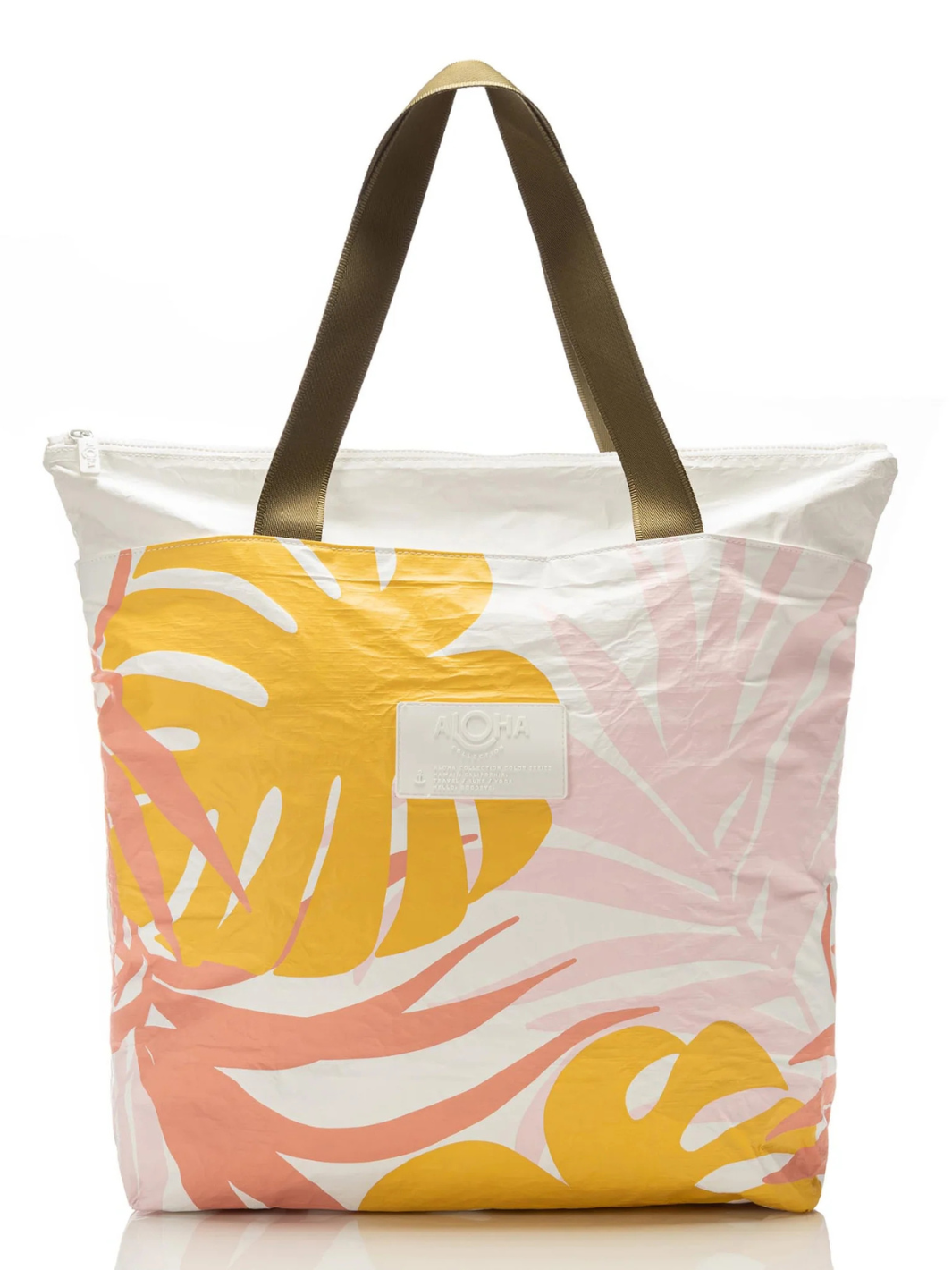 ALOHA Tropics tote with pink and yellow palm leaf print and bronze-brown handles.