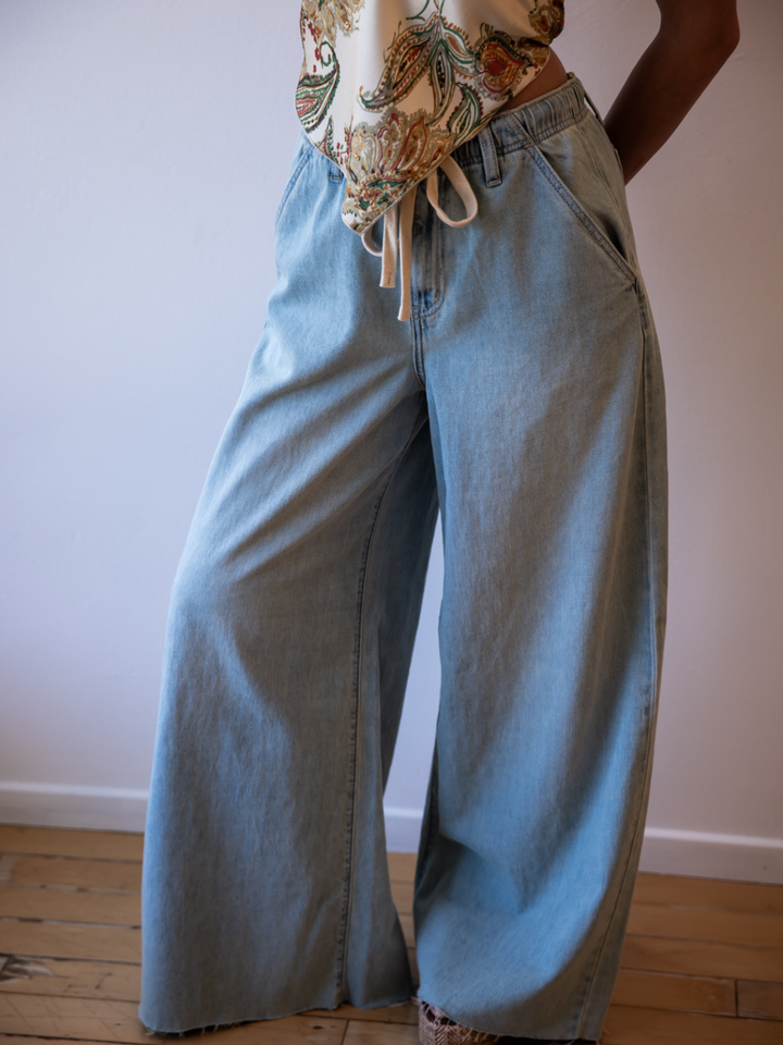 Daze Denim Cabana Wide Leg Pull-On Jeans in light wash, worn with a floral top.