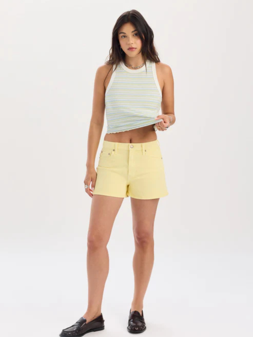 DAZE DENIM Troublemaker High Rise Short in Cream worn with a striped tank top.