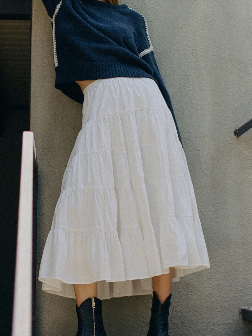 Coastal Dream Tiered Ruffle Midi Skirt in white, styled with navy knit top and boots.