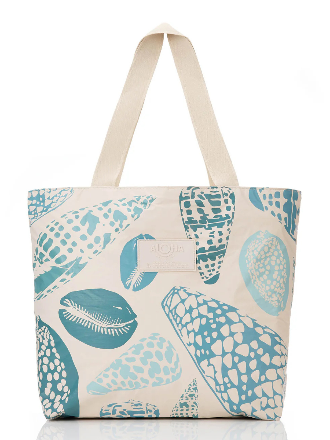 Shoreline tote bag with teal shell patterns and beige handles from the ALOHA Collection.