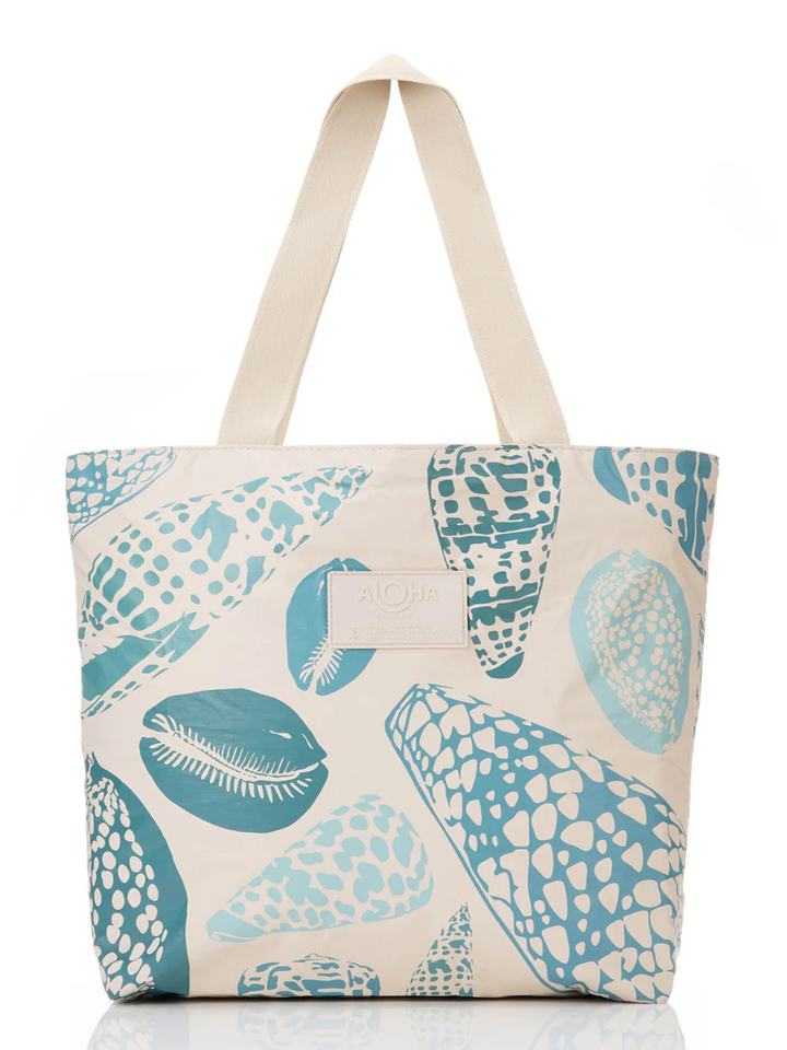 Shoreline tote bag with teal shell patterns and beige handles from the ALOHA Collection.