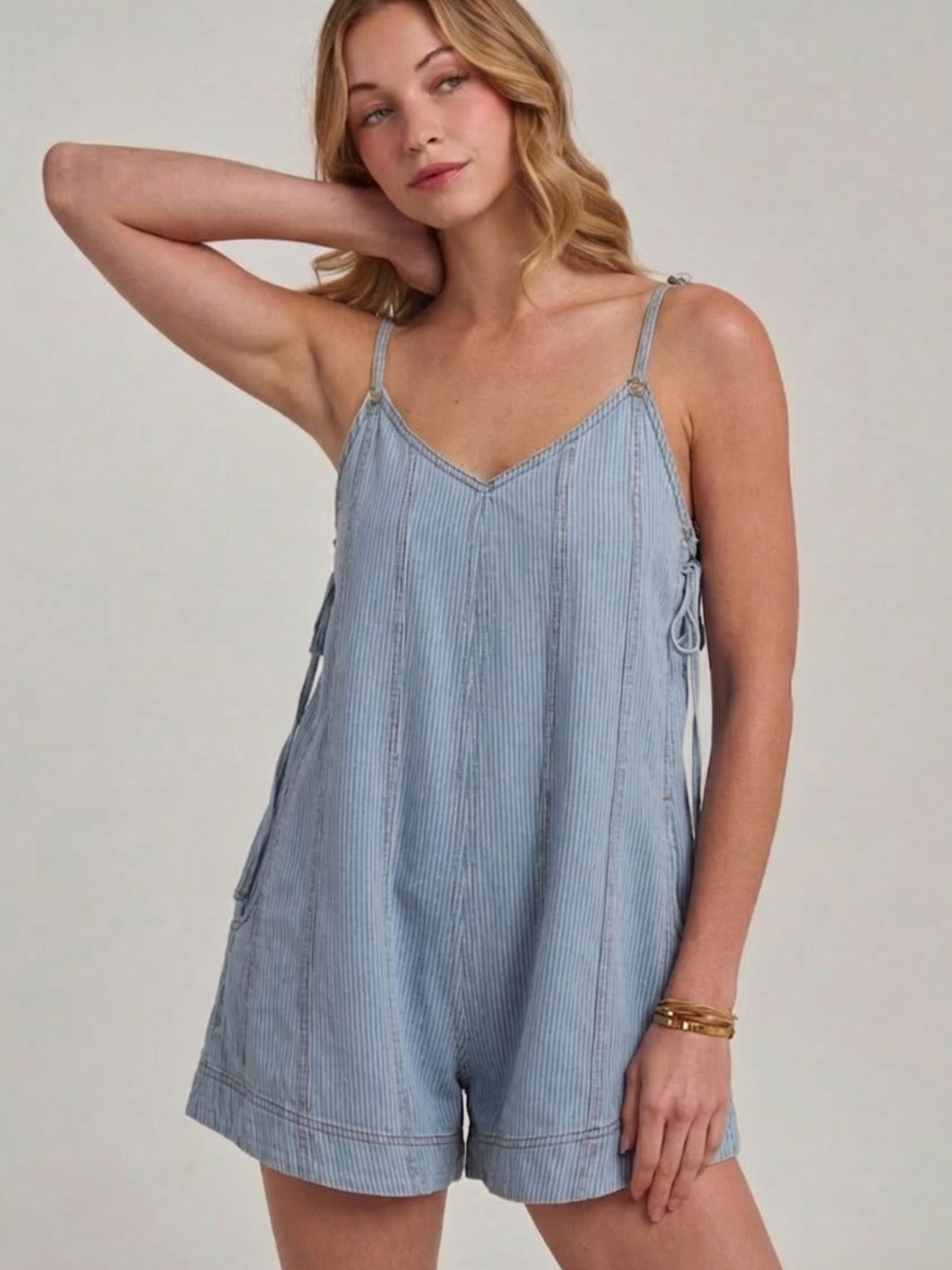 Sundaze Pin Stripe Denim Romper in light wash with thin straps and relaxed fit.