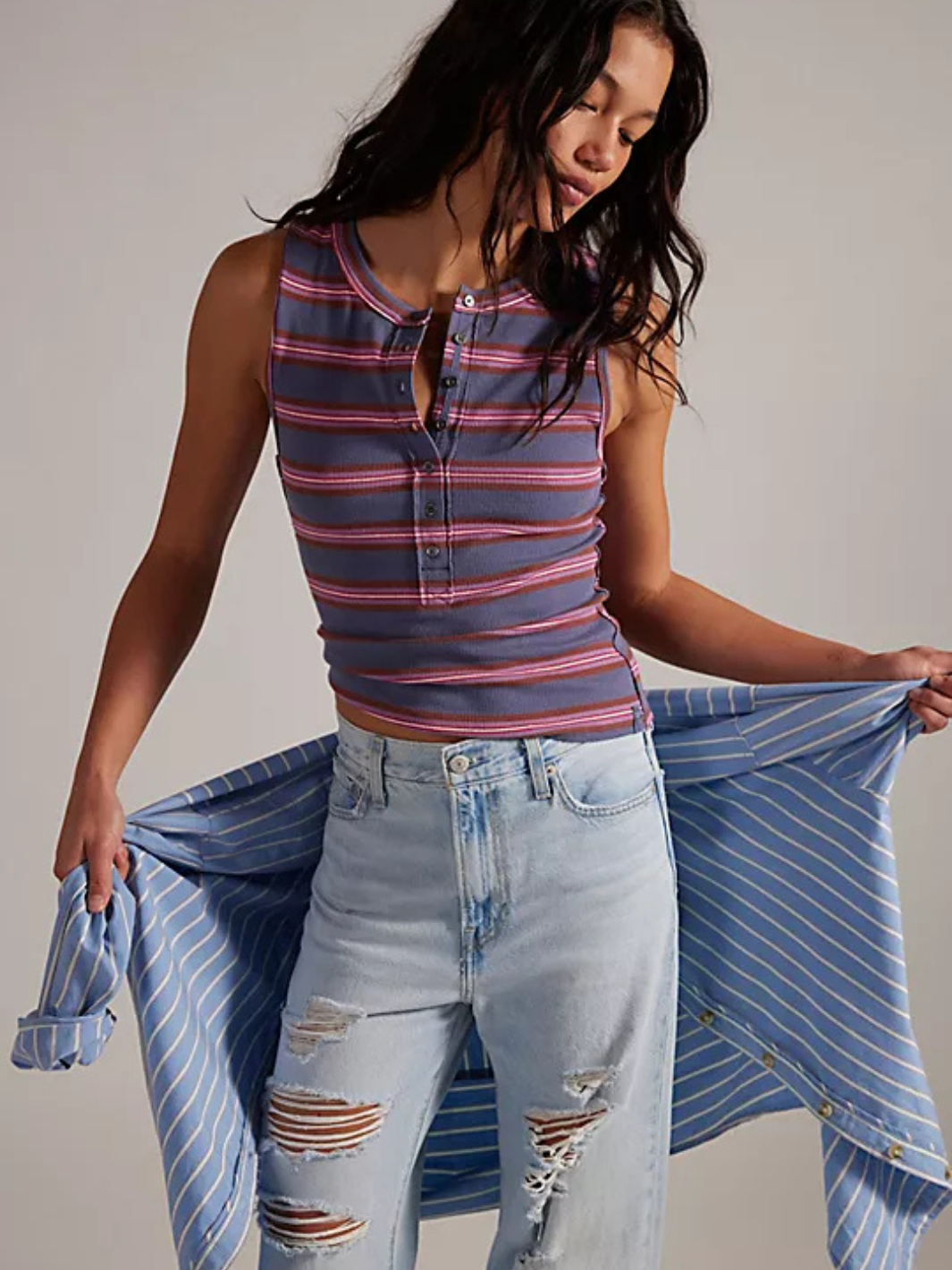 Free People Jamie Henley Striped Tank Top on model; blue-purple striped sleeveless henley with button placket.