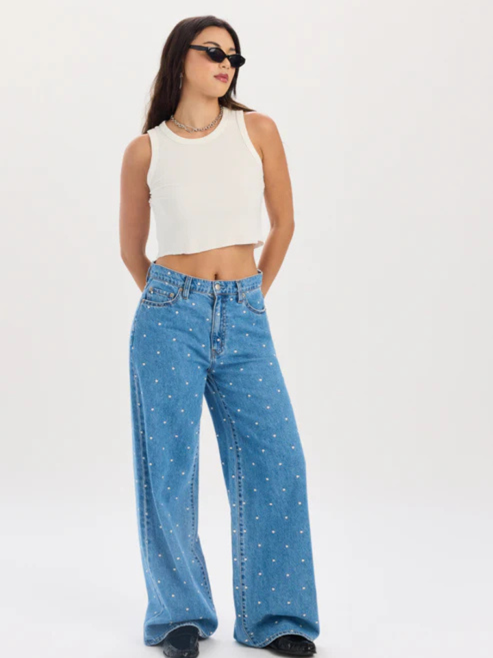 Daze Denim The Wanderer mid-rise palazzo jeans in blue with white dots, shown with a white crop top.