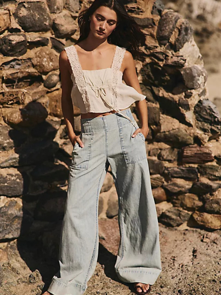 Free People We The Free Breezy Denim Pull-On Jeans, mid-rise light-wash wide-leg with front pockets.