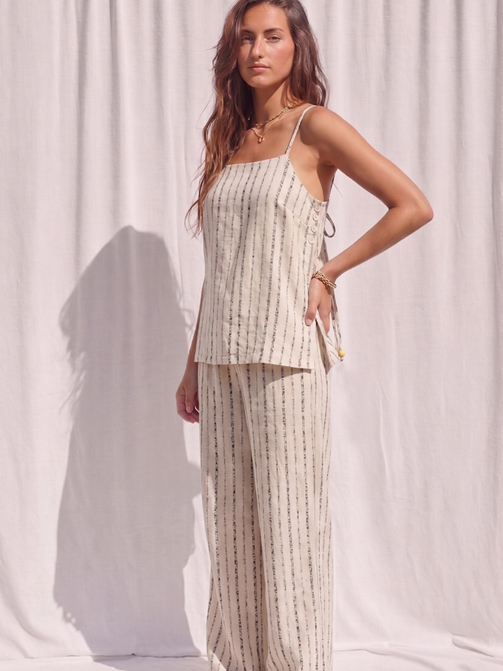 Model wearing beige coastal stripe wide-leg drawstring pants with a matching sleeveless top.