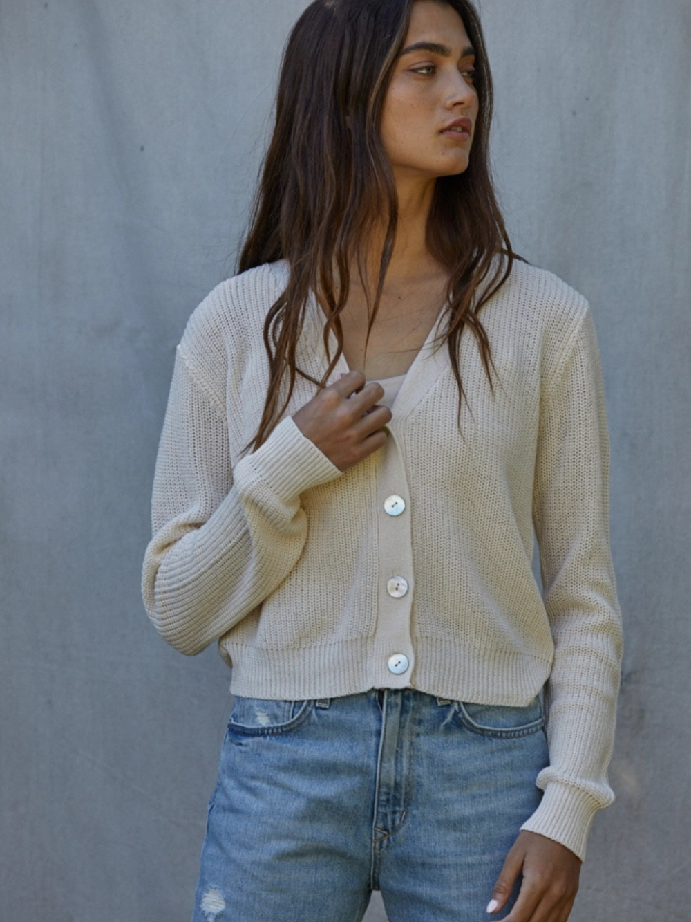 Golden Hour V-Neck Button-Front Knit Cardigan in cream, open-knit with large buttons, over white top and denim jeans.