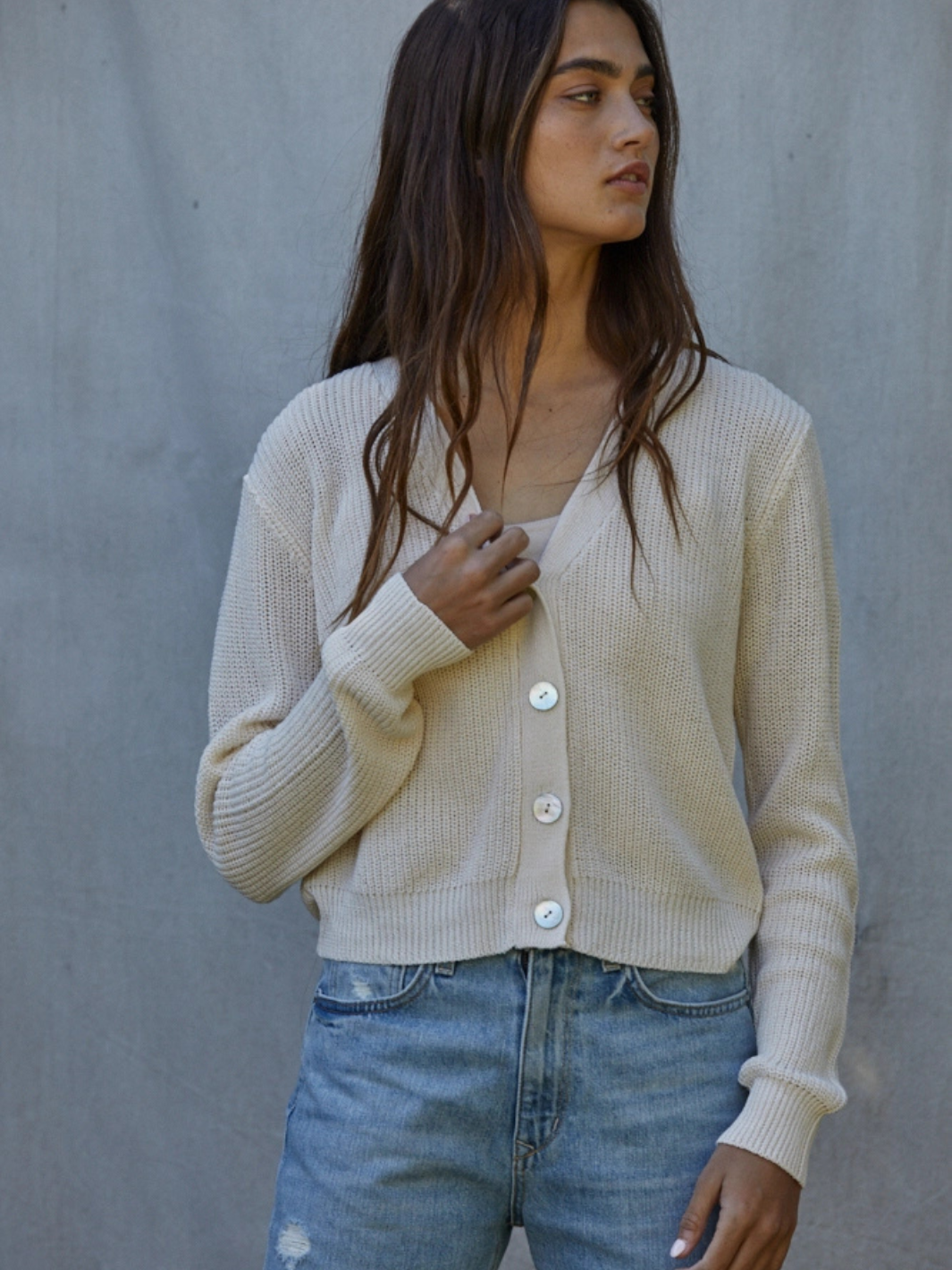 Golden Hour V-Neck Button-Front Knit Cardigan in cream, open-knit with large buttons, over white top and denim jeans.