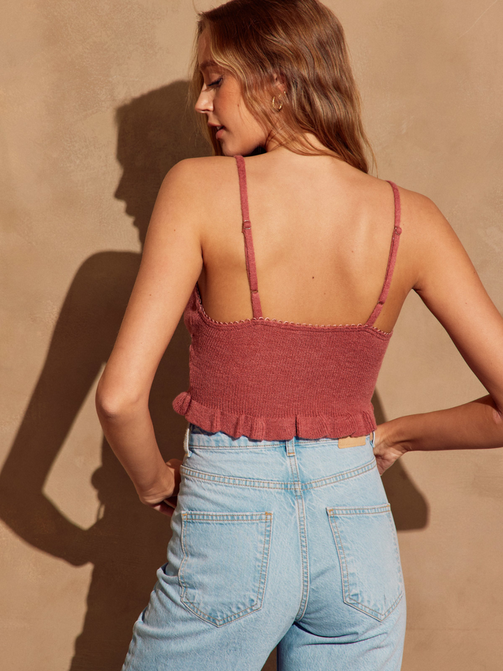 Maverick Cropped Knit Top features a delicate scalloped neckline and ruffle hem, perfect for sunny days and casual outfits.
