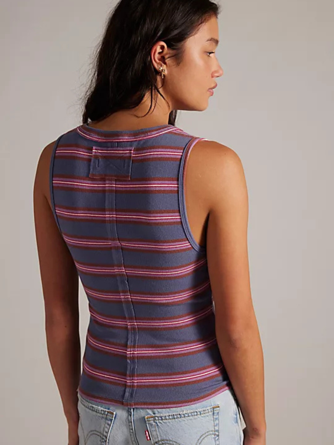 Jamie Henley Striped Tank Top back view on a model, blue-gray with red stripes, denim jeans.