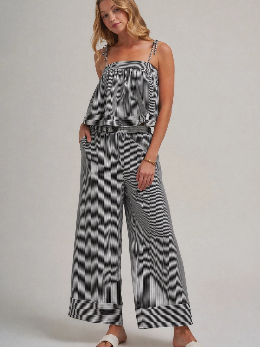The Portofino Striped Flowy Cami Top with tiered overlay and self-tie straps, paired with matching wide-leg pants.
