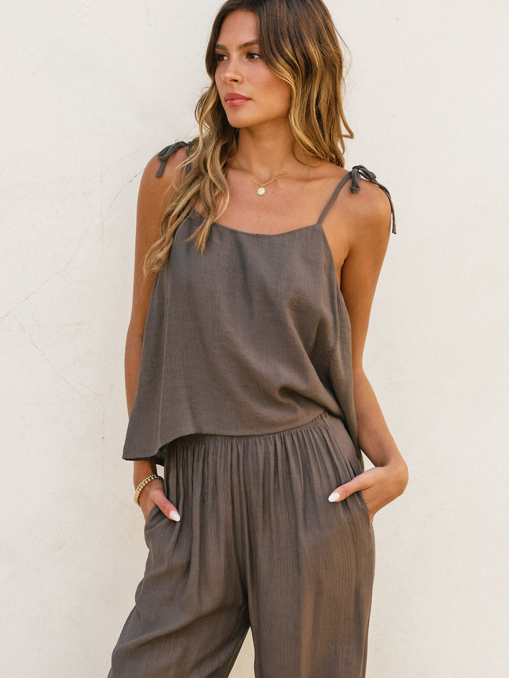Stylish model wearing the Level Up Shoulder Tie Up Top, perfect for warm weather and effortless chic looks.