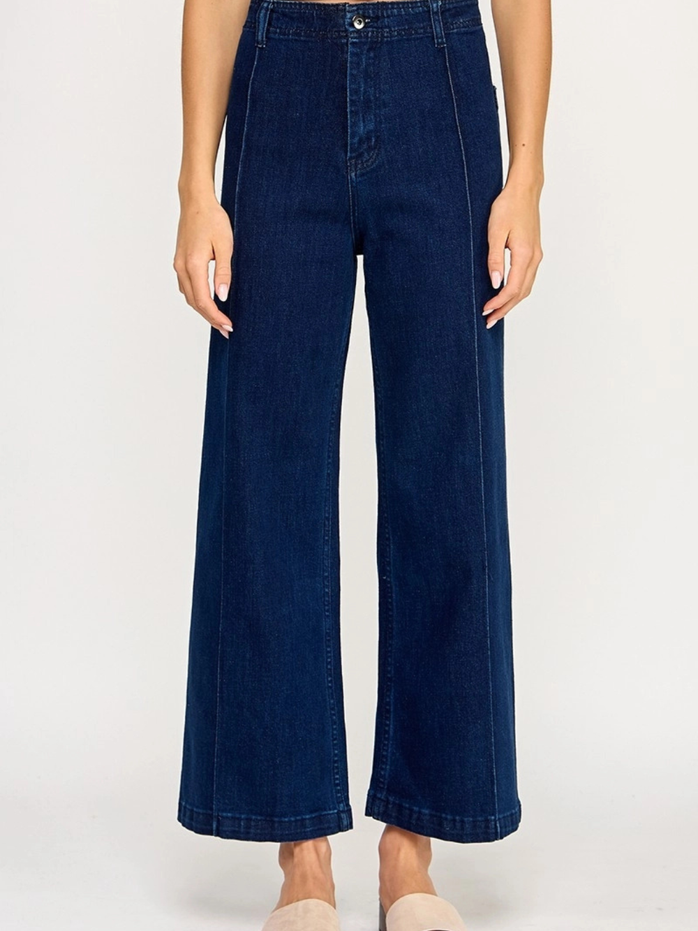 Back view of The Sundaze dark wash high-rise wide-leg jeans showing oversized patch back pockets and contrast stitching detail on clean indigo denim