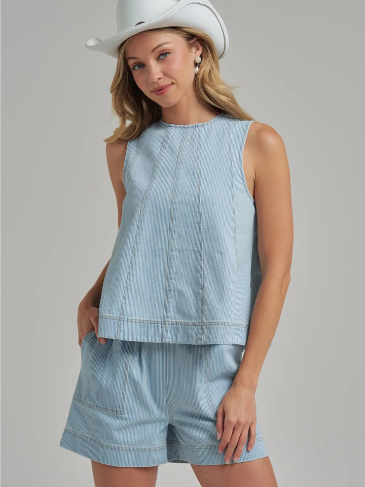 The Sutton Pinstripe Denim Tank Top with matching light-blue shorts; sleeveless, panel-seamed denim.