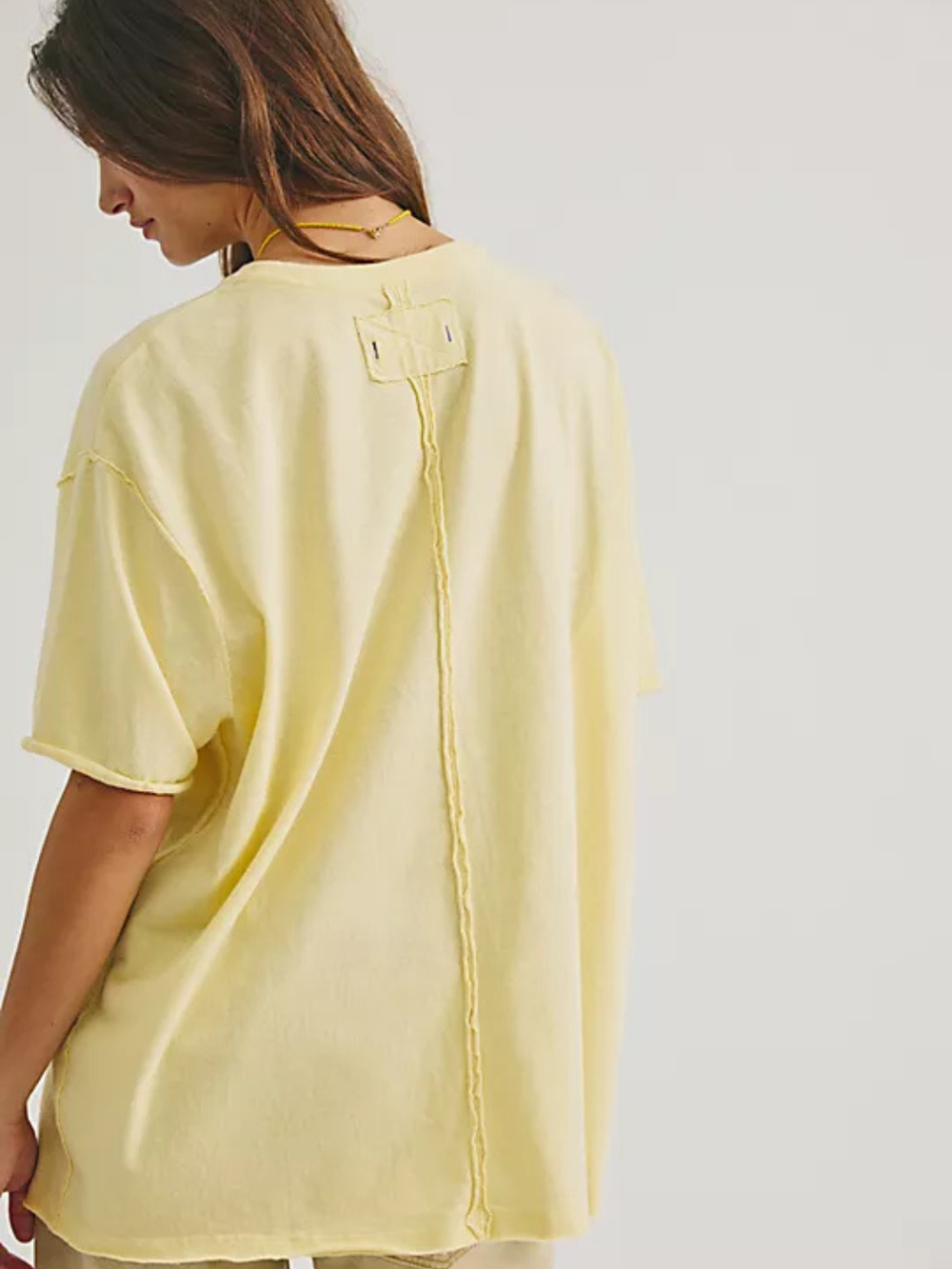 Free People We The Free Best Coast Tee in pale yellow, oversized with back seam and back neck tag.