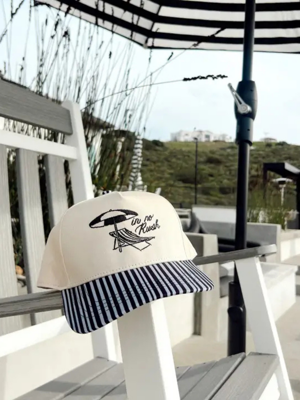 Stylish In No Rush - Black Striped Bill Trucker Hat with Ruby Moon logo, perfect for comfort and casual outings.