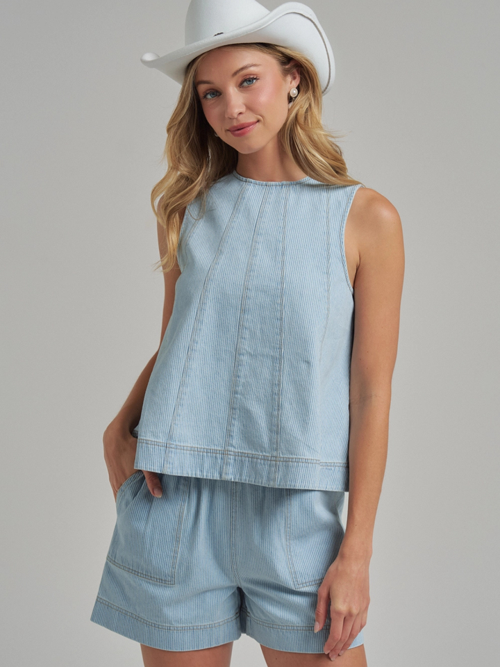 The Sutton Pinstripe Denim Shorts worn by a model, paired with a matching light-denim top for a casual yet tailored look.