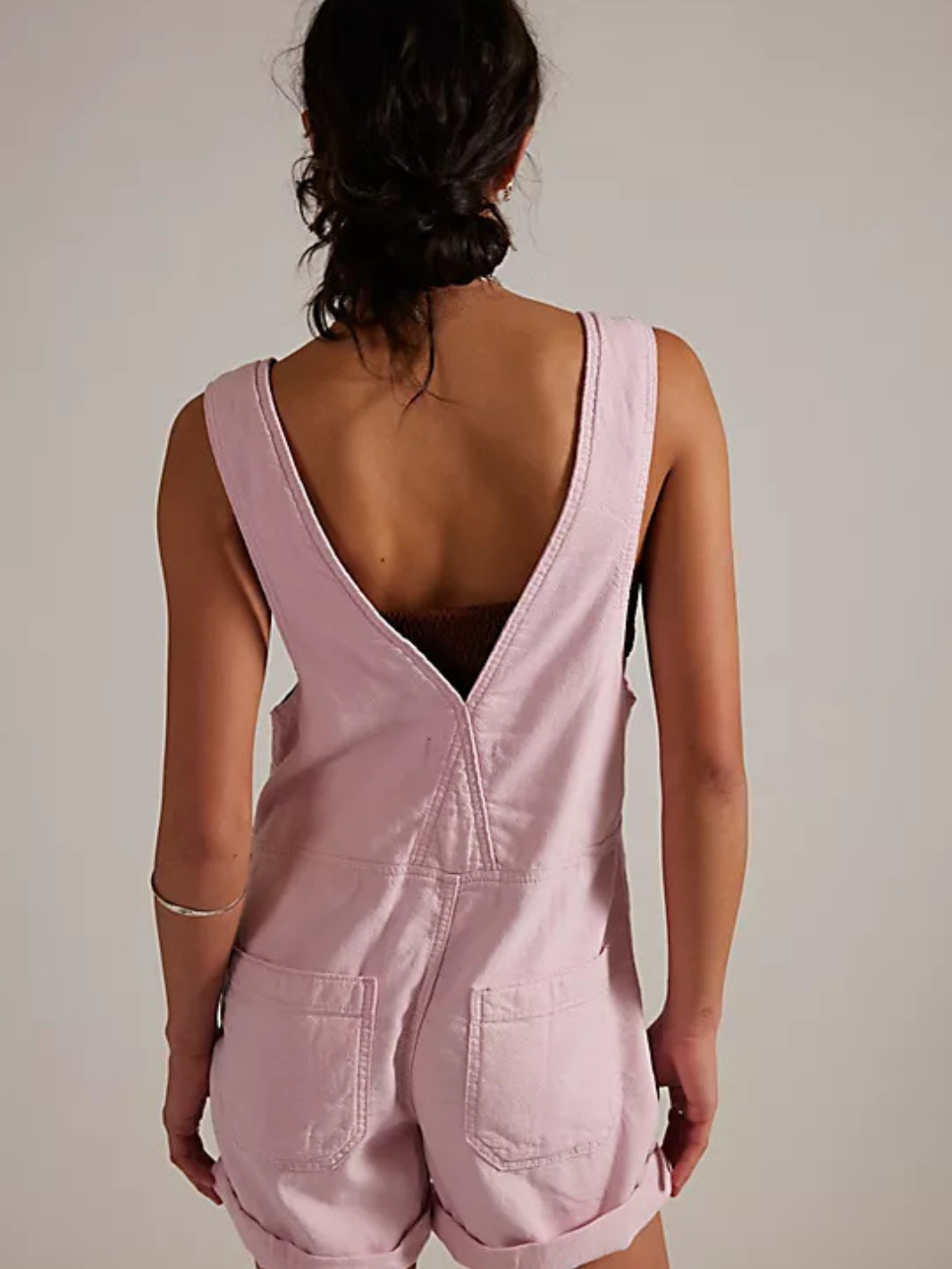 We The Free Jude Shortalls in pale pink, back view with a deep V-back and rear patch pockets.