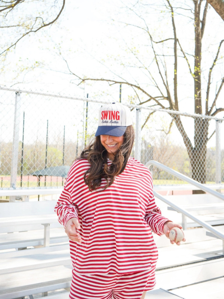 KENZKUSTOMZ Swing Batter Batter Pinstripe Baseball Cap on a smiling woman wearing a red-and-white striped outfit outdoors.