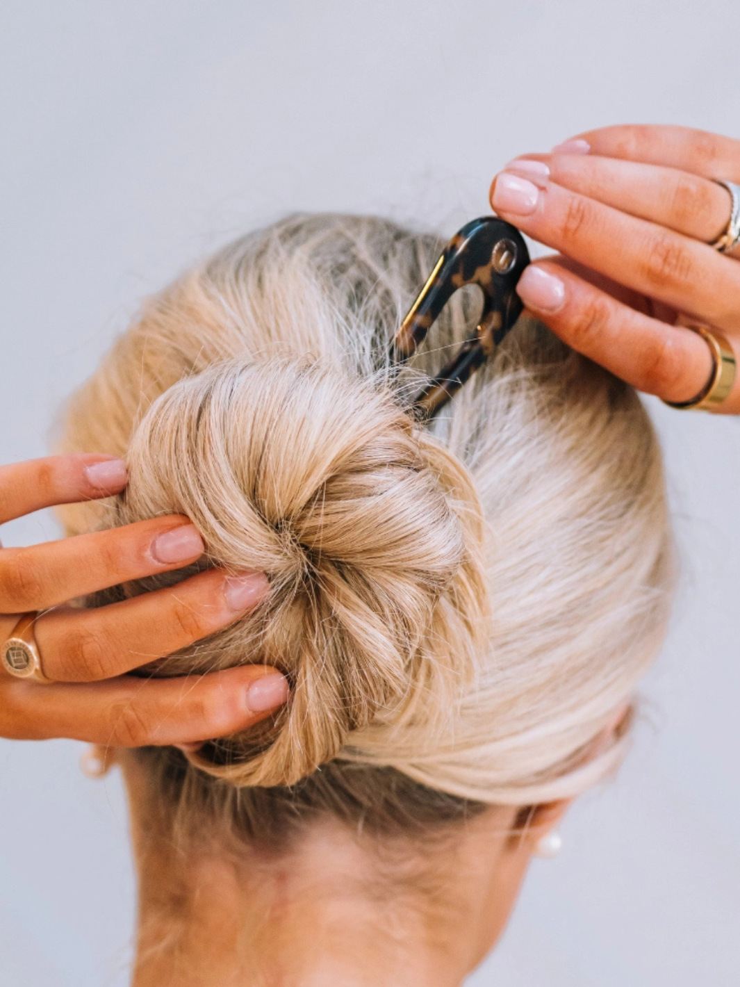 Blonde hair bun secured with tortoiseshell TELETIES French Hair Pin.