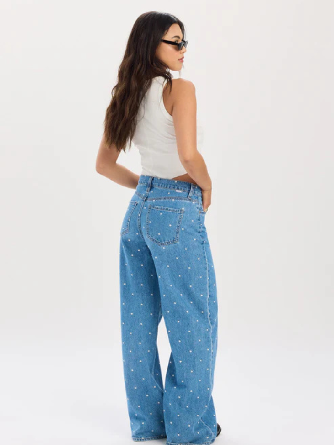 Daze Denim The Wanderer Mid-Rise Palazzo Jeans on model, wide-leg blue denim with white polka dots, back view.
