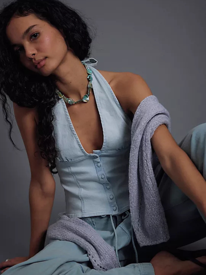 Free People Ramona Denim Halter Top: fitted light-denim with corset-inspired seaming, styled with a lavender cardigan.