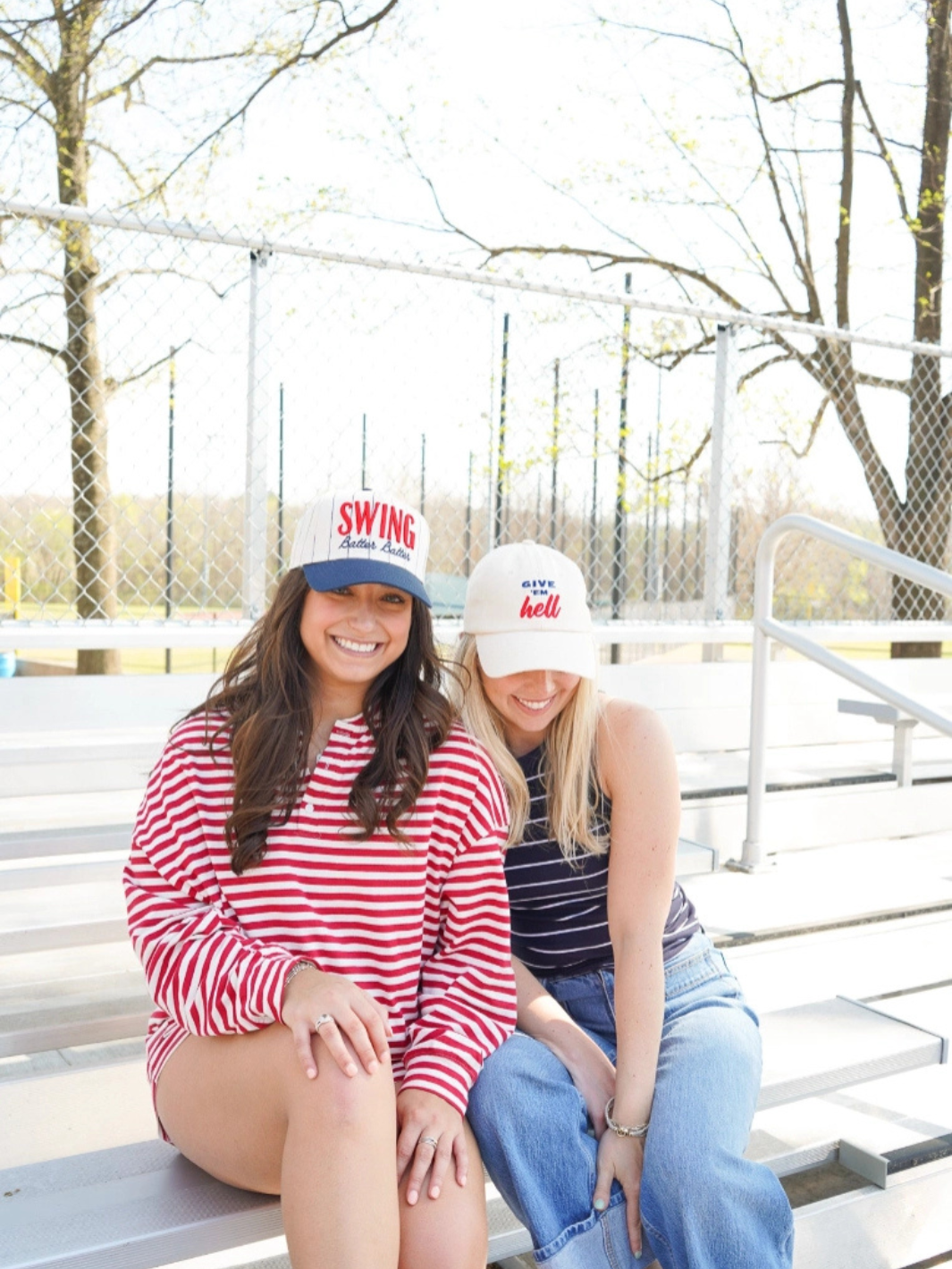 KENZKUSTOMZ Swing Batter Batter Pinstripe Baseball Cap worn by two women on ballpark bleachers.