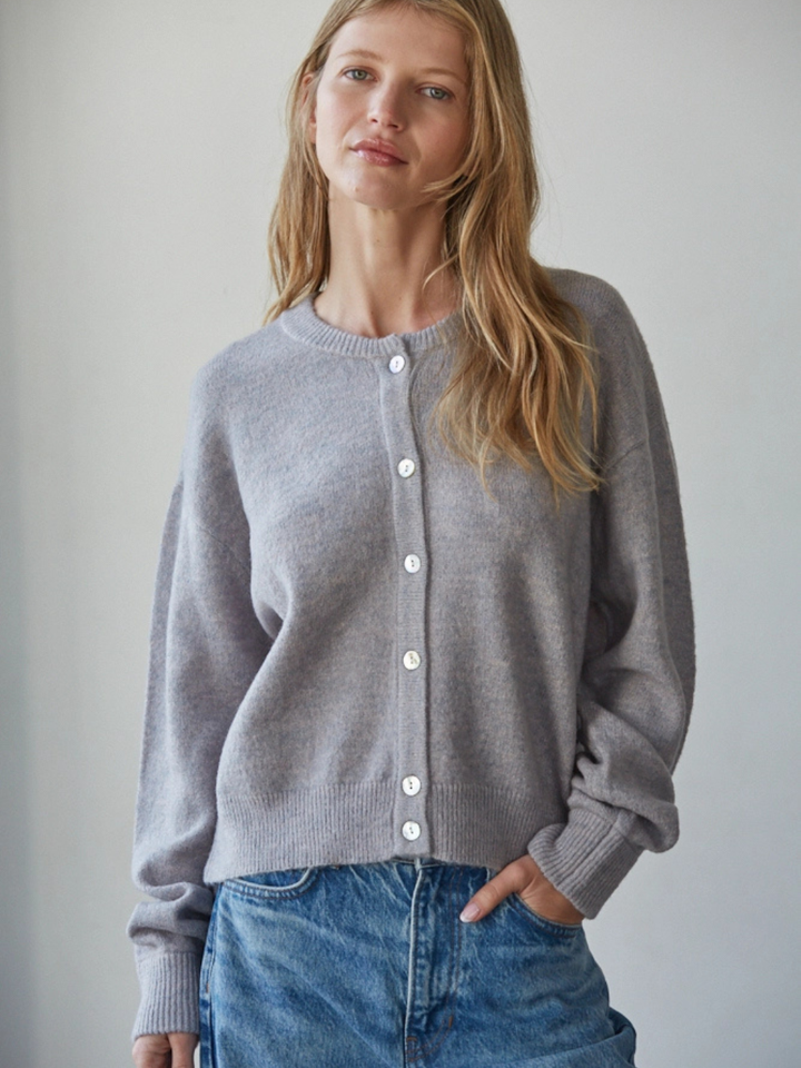 Model wearing Sunday Soft Button-Front Knit Cardigan in light grey, relaxed cropped fit with white pearl buttons.