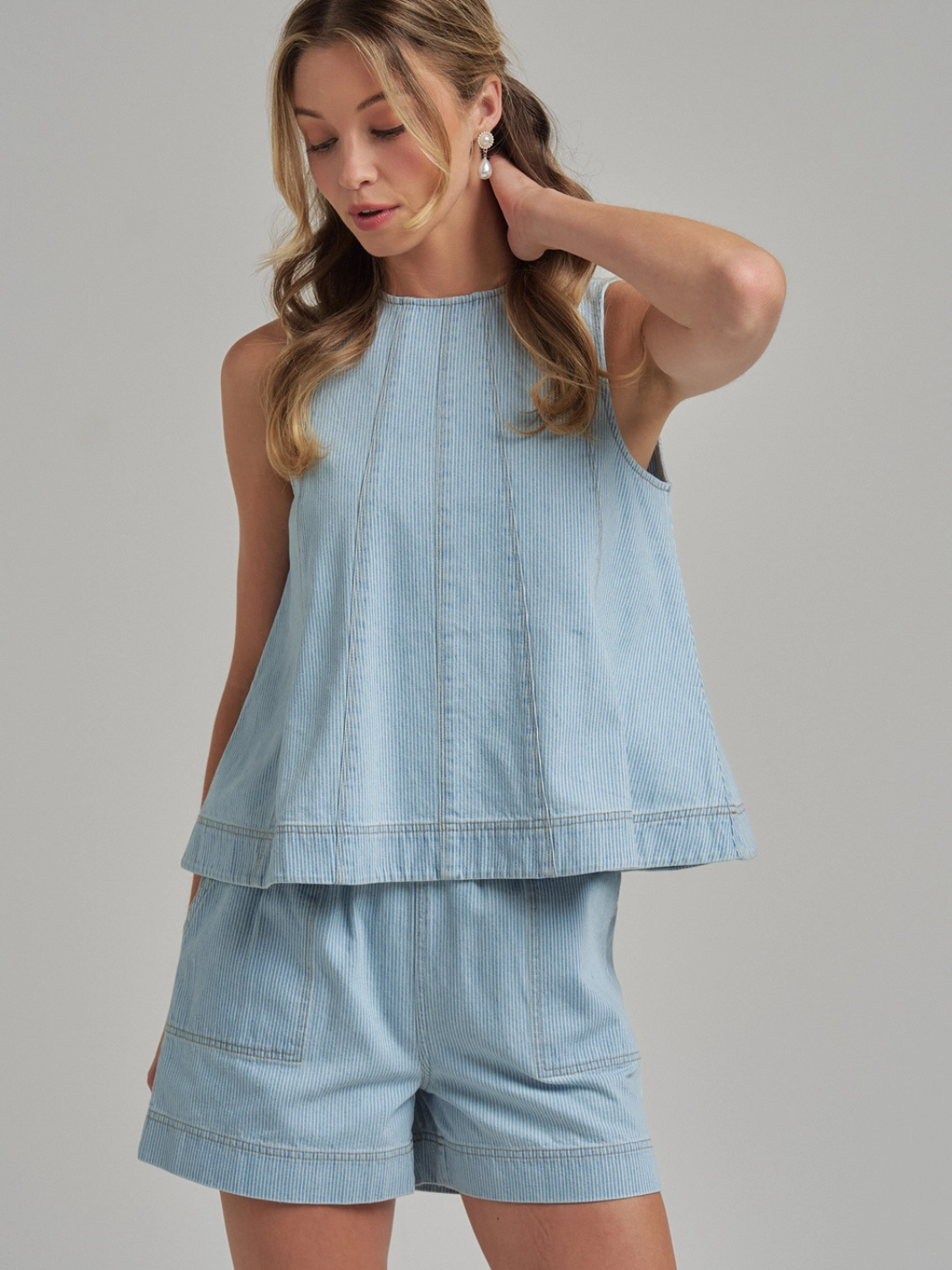 The Sutton Pinstripe Denim Shorts with panel-seam structure in light wash, styled with the matching Sutton tank.