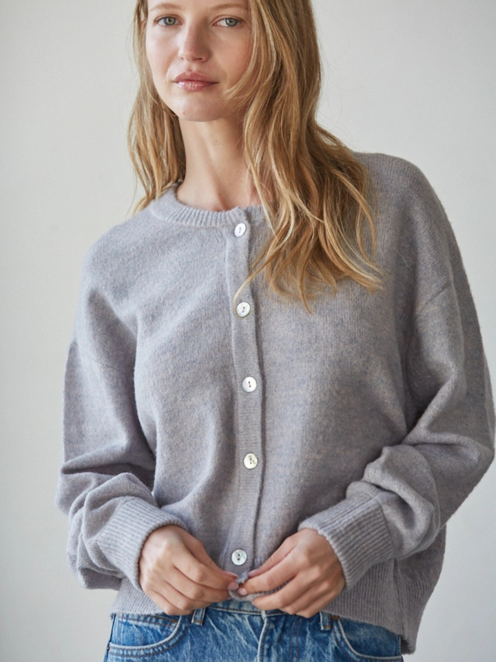 Model wears Sunday Soft Button-Front Knit Cardigan in gray; relaxed cropped fit, crew neckline, pearl-button front.