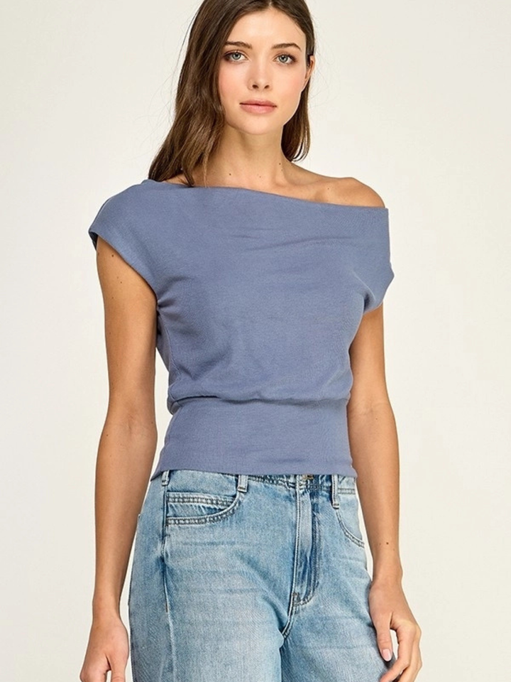 Malibu slate blue off-shoulder stretch knit top on a model wearing light denim jeans.