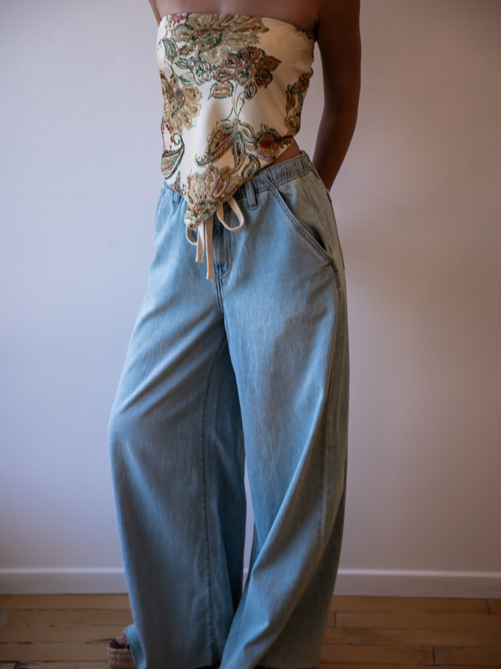 Daze Denim Cabana Wide Leg Pull-On Jeans in a light wash, paired with a floral top.