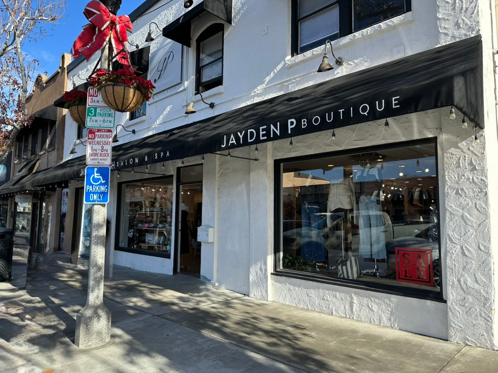  storefront with 'Jayden Boutique' sign on a sunny day