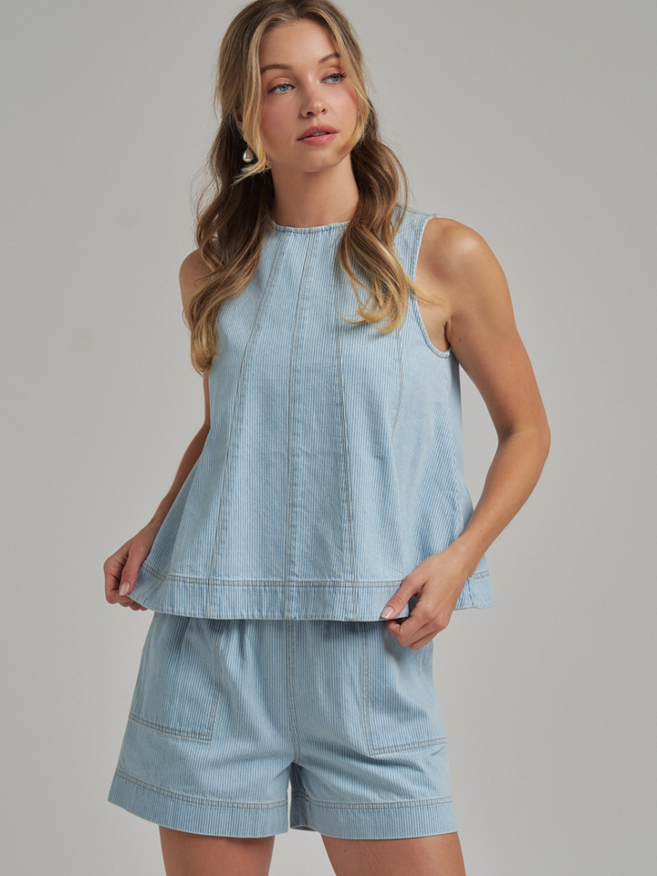 The Sutton Pinstripe Denim Tank Top with matching light-blue pinstripe shorts; sleeveless, structured.