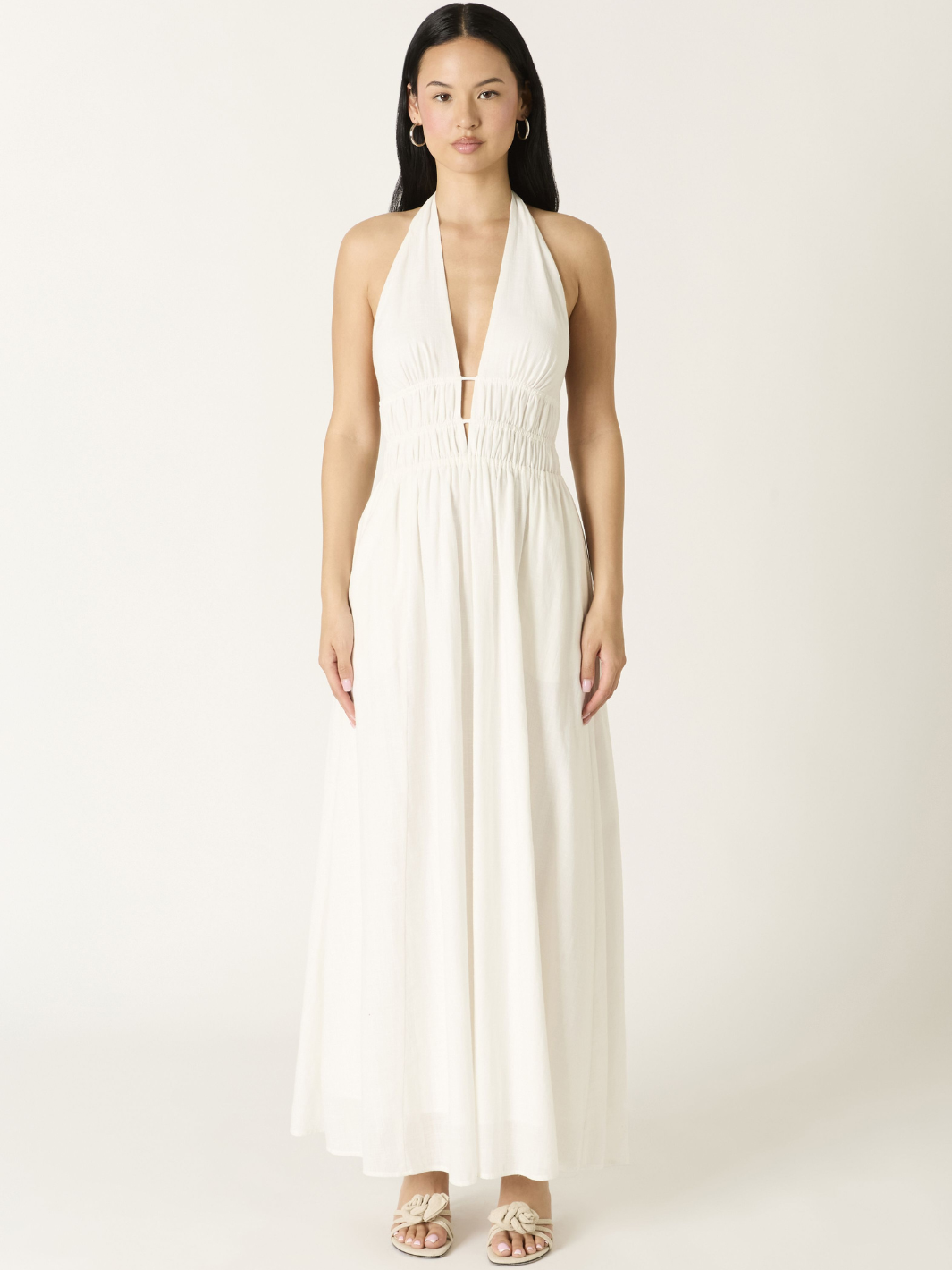 Soleil Plunge Halter Maxi Dress on model with deep V neckline, ruched waist, and flowing A-line skirt.