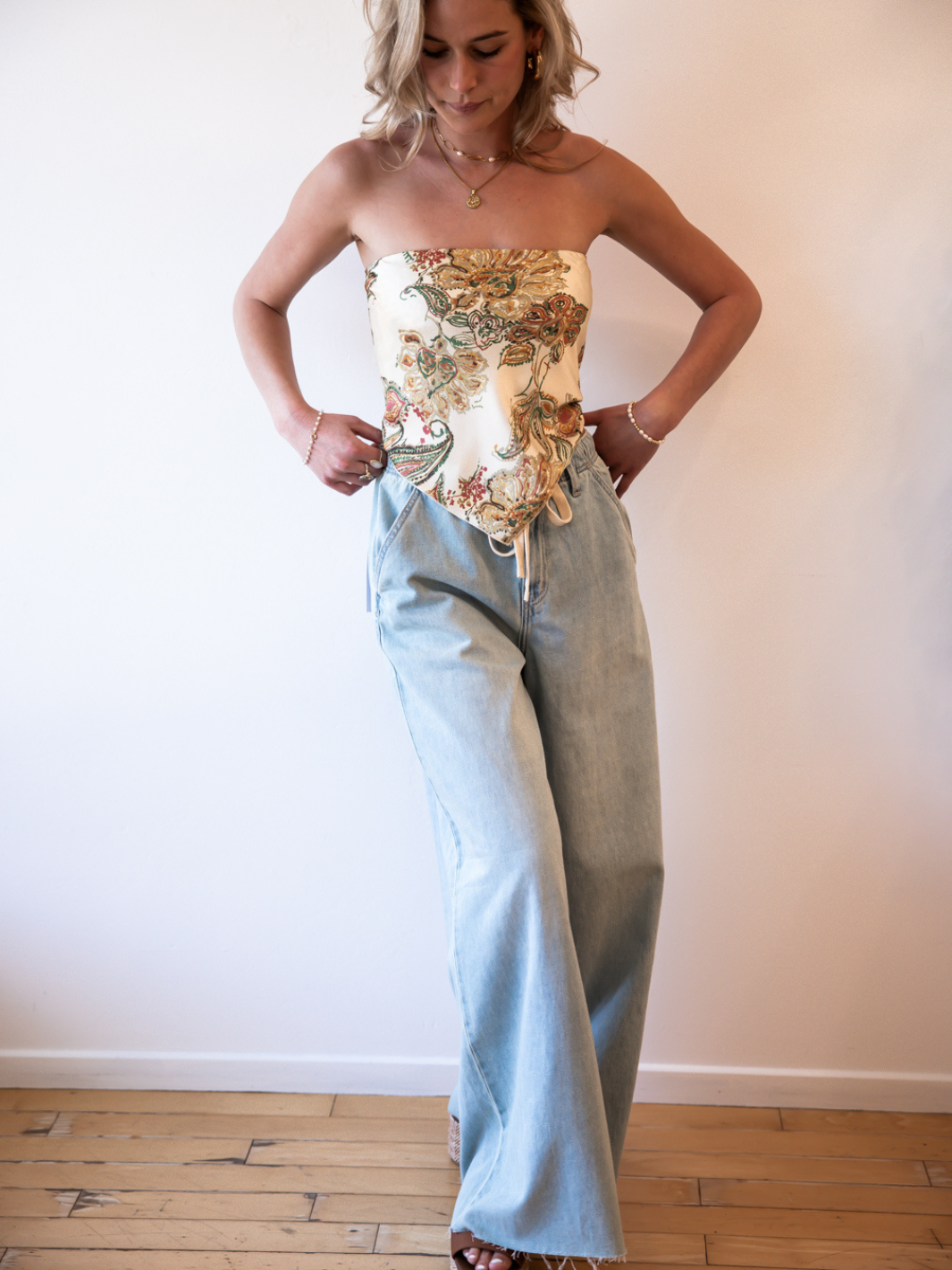 Daze Denim Cabana Wide Leg Pull-On Jeans in light wash, modeled with a floral strapless top.