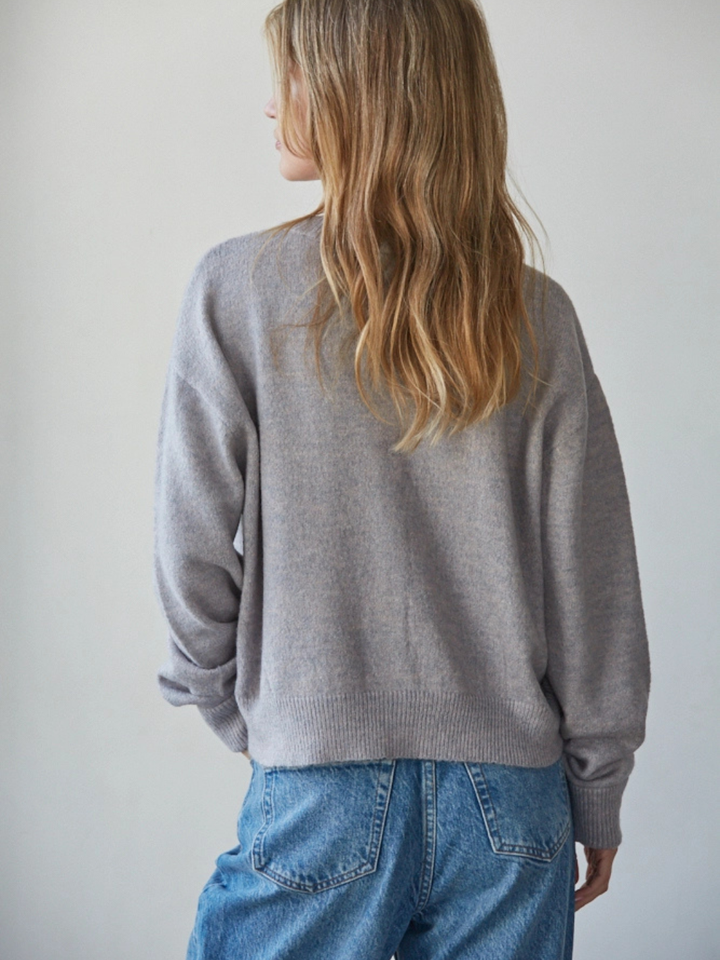 Back view of light gray Sunday Soft Button-Front Knit Cardigan on model with relaxed cropped fit.